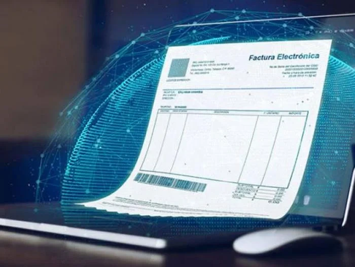 Nuevos cambios en el sistema de facturación electrónica mostrados con una factura digital sobre un portátil.